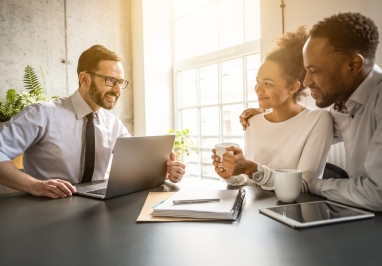 Couple meeting with a man and a laptop